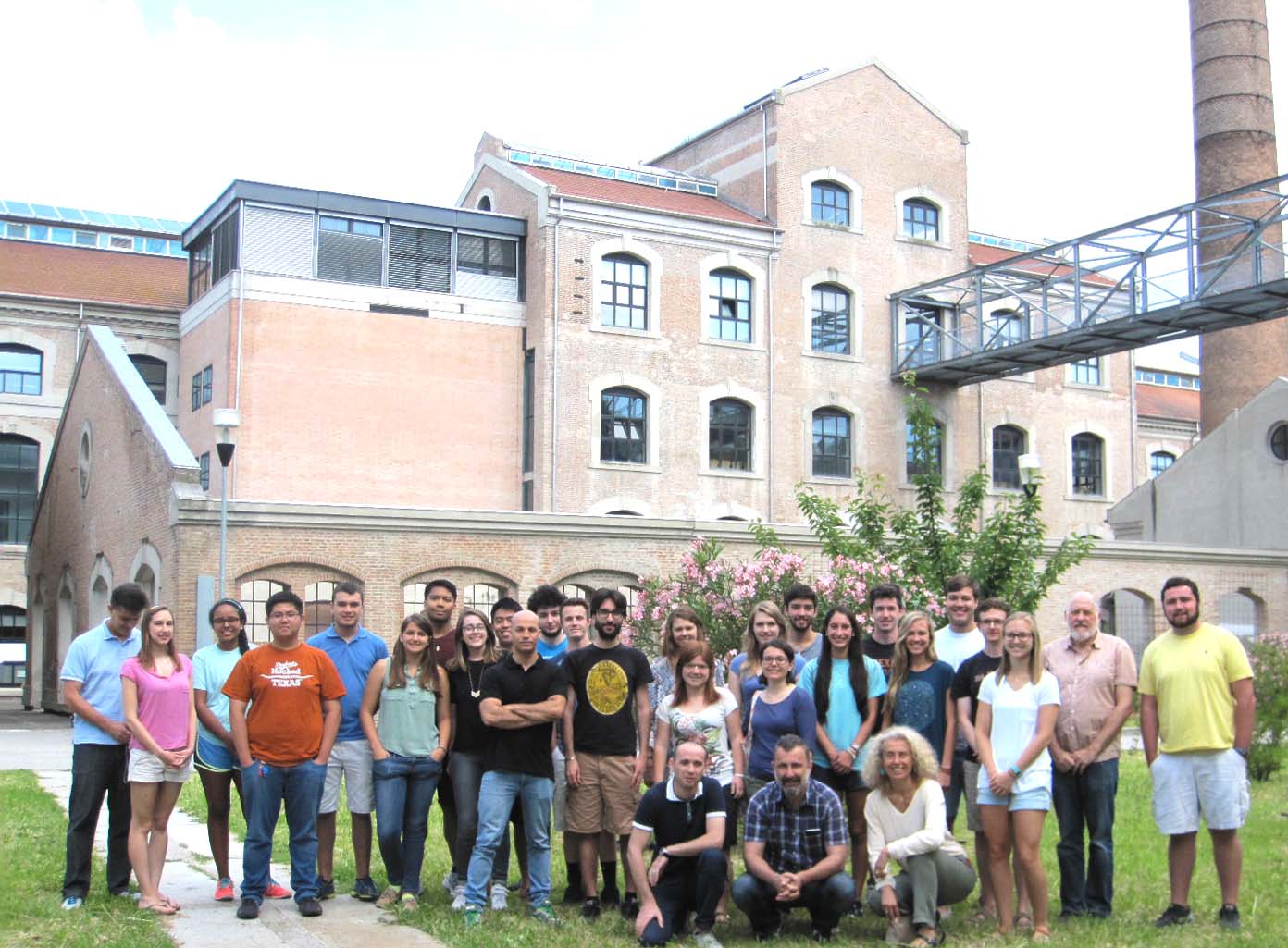 group of students standing in front of a brick building in Italy